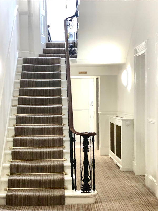 Historic grand staircase inside 128 Harley Street townhouse