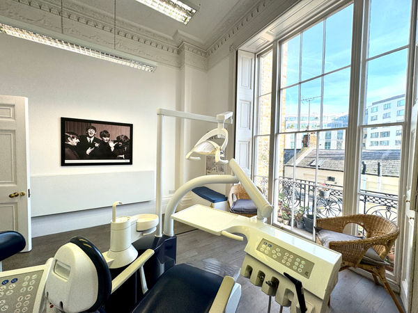 Modern dental surgery overlooking London rooftops with framed art